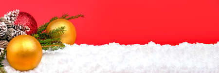 Christmas decorations ornaments lie in the snow. Christmas card with copy space. Happy New Yearの写真素材