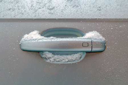 Car door handle in snow, first snow, snowfall, unexpected snowの写真素材
