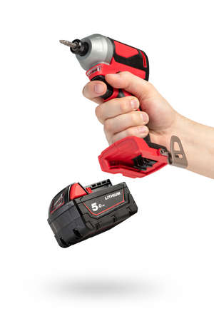 Drill in hand on a white isolated background. Cordless drill or screwdriver in a male hand....