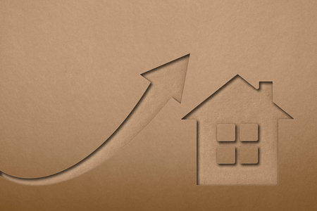 Green ecological house symbol. The value of ecological real estate. House symbol on paper texture background. Growing popularity of renewable energy sources.の写真素材