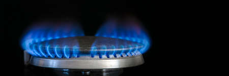 Combustion of natural gas, propane. Gas stove on a black background. Fragment of a gas kitchen stove...