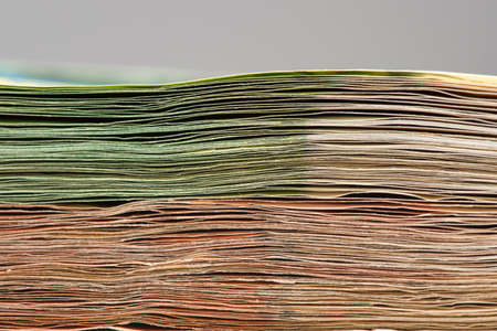 Close-up of a stack of paper bills, side view. Euro banknotes stacked on top of each other. Big pile...