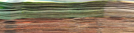 Close-up of a stack of paper bills, side view. Euro banknotes stacked on top of each other. Big pile...