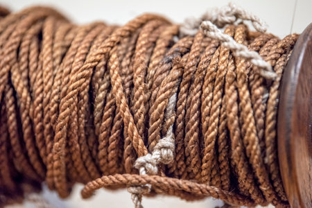 old rope. Thick tangled rope close up. Close-up of an old worn out boat rope as a nautical background.の写真素材