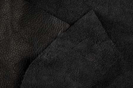 Black suede close-up. Natural black suede texture for design or project. Velvet, leather reverse.