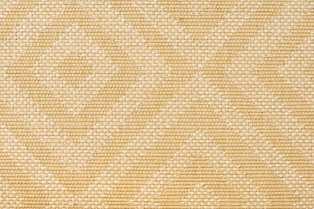 Texture of fabric for furniture upholstery in beige color with rectangular patterns or rhombuses....