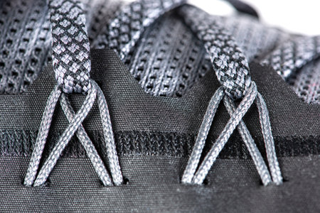 Sneakers close-up. Shoelaces of new sports shoes in gray, lacing sneakers close-up, top view. Mesh...