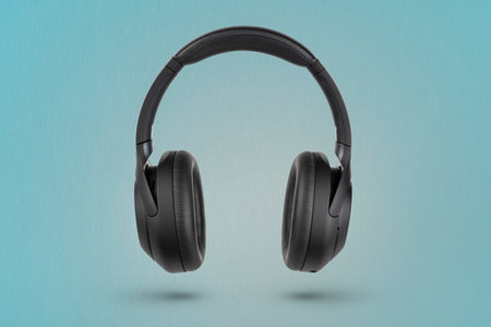Headphones on a blue background. Wireless headphones in black, high quality, for advertising or product catalog.の写真素材