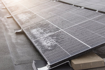 Solar panel in winter. Solar panels are covered with snow on the roof of the building, the use of...