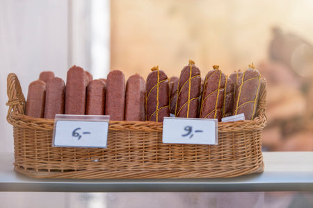 Different sausages lies in a basket. Sausages are made from meat.の写真素材