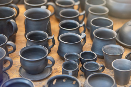 Products from black ceramics of handwork. The craftsman sells many ceramic pots in the market. The concept of a small business for the production of dishes.の写真素材