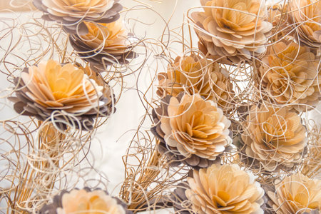 Decorative flowers are made of wood. Flowers small business concept. Mini factory of wooden flowers.の写真素材