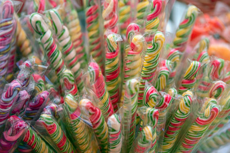 Sweets are harmful to health. Multi-colored sweets with a lot of sugar, in the form of sticks, are sold in a pastry shop.の写真素材