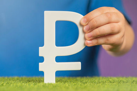 Ruble symbol in hands on a purple background. The concept of the growth or fall of the value of the ruble in the economy. Banner on financial topics. Recession and crisis in Russia.の写真素材