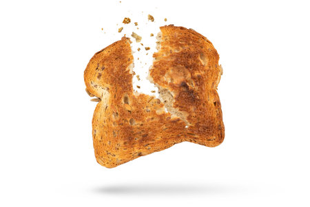 White bread slice isolate broken into 2 pieces with flying crumbs. Toaster fried bread isolated on white background. The concept of a small, dietary crispy breakfast.の写真素材