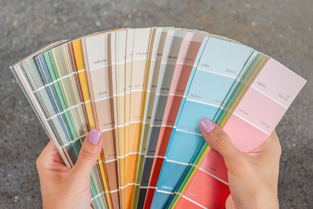 Color selection according to RAL. A woman designer chooses a shade from the RAL color palette. The...