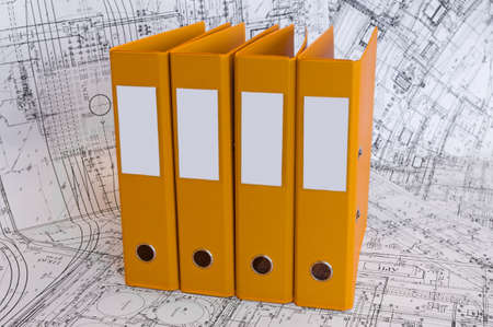 Row from the yellow file folders with clean blank for your text. Black and white project drawings...
