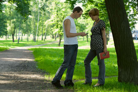 Teenagers: man meets a woman in park and tries to make the acquaintanceの写真素材