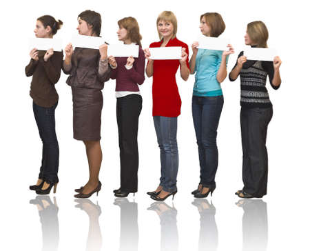 Six beautiful models a women stand on white background in studio. Full-length portrait. White billboards for simple text in hands. Isolated over white. One in red dress.の写真素材