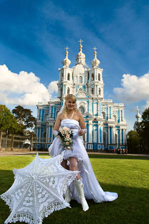 The beautiful bride about a temple before wedding. A sunny day の写真素材