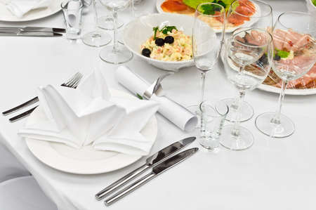 Table appointments for dinner in restaurant. Detail of a fancy table set for holiday dinnerの写真素材