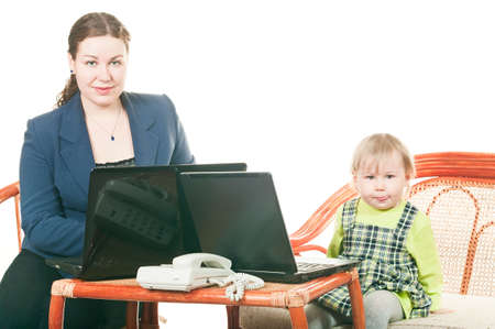 The small child and young mother together work on laptops, sitting at a table. It is isolated on a white backgroundの写真素材