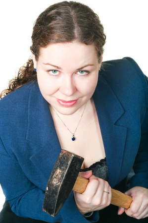 The young beautiful girl with a hammer in hands. It is isolated on a white backgroundの写真素材