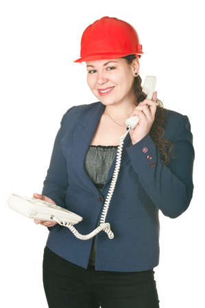 The girl in a red helmet calling by phone. Isolated on white backgroundの写真素材