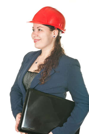 The girl in a red helmet with the laptop sits at a table. Isolated on white backgroundの写真素材