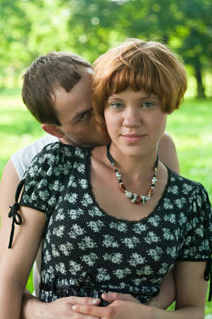 Young loving kissing couple teens. Two Caucasian people. Teenagers: girl and boy embracing one anotherの写真素材