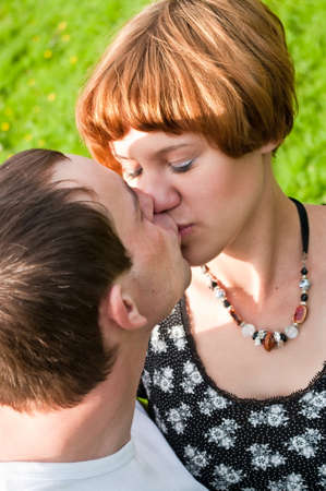 Young loving kissing couple teens. Two Caucasian people. Teenagers: girl and boy embracing one anotherの写真素材