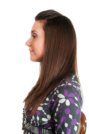 Portrait of beautiful young woman in profile isolated on white background. Long hair brunetの写真素材
