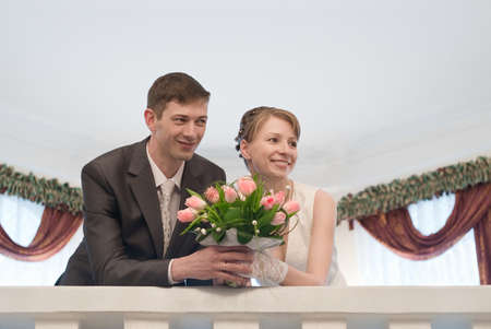 Young loving wedding couple with bunch of flowers. Newlywed pairの写真素材