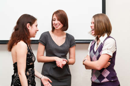 Three business women talking togther in office roomの写真素材