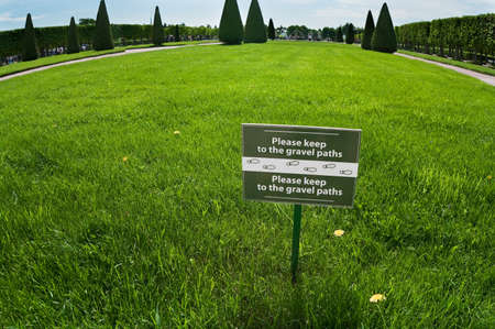 Please, do not keep gravel path. Tag with notice on green grassの写真素材