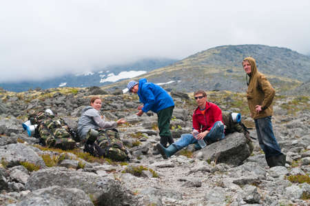 Group of travelers in mountains with knapsacks are restingの写真素材
