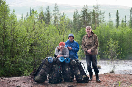 Group of travelers trekking in forest Mountaineering with knapsacksの写真素材