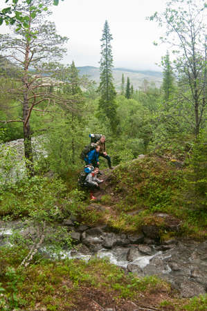 Group of people climbing and trakking in hillsの写真素材