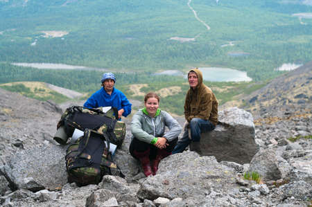 Group of travelers in mountains with knapsacks are restingの写真素材