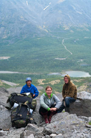 Group of travelers in mountains with knapsacks are restingの写真素材