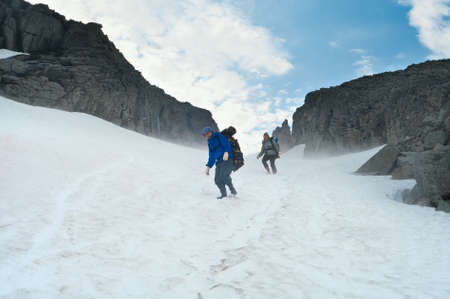 Climbers walking on top of mountain on snow. の写真素材