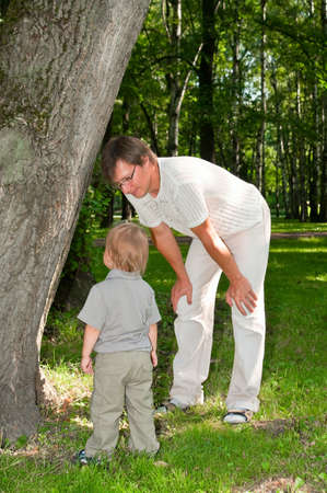 Father and little child in park in summer dayの写真素材