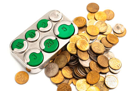Moneybox coin holder and small change isolated on white background