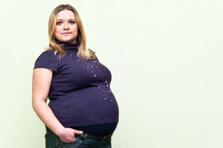 Pregnant young caucasian woman standing. Copy spaceの写真素材