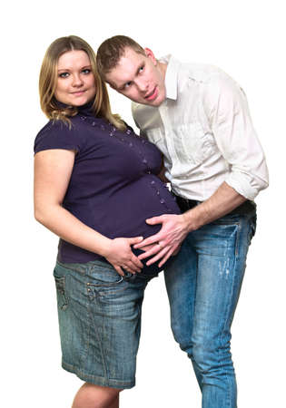 Pregnant woman with her husband isolated on white background. Caucasians, a loving young coupleの写真素材