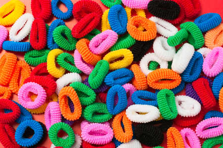 Background from colored hair binders. Close upの写真素材
