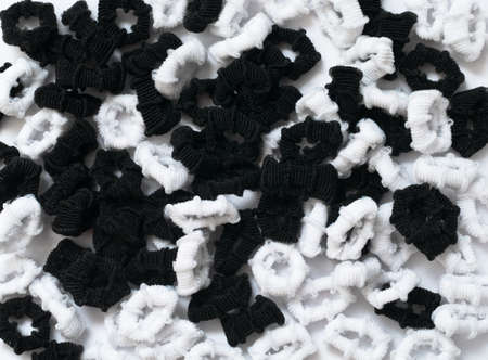 Background from black and white hair binders. Close upの写真素材