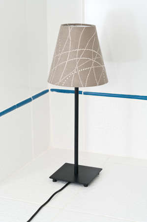 Electric table lamp on white tile backgroundの写真素材