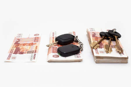 House and car keys on stack of Russian money on white backgroundの写真素材