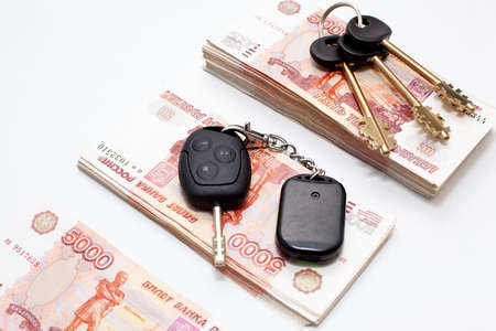 House and car keys on stack of Russian money on white backgroundの写真素材
